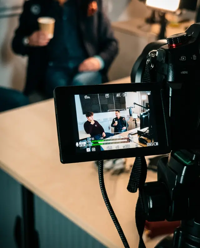 A camera monitor framing an interview during a shoot